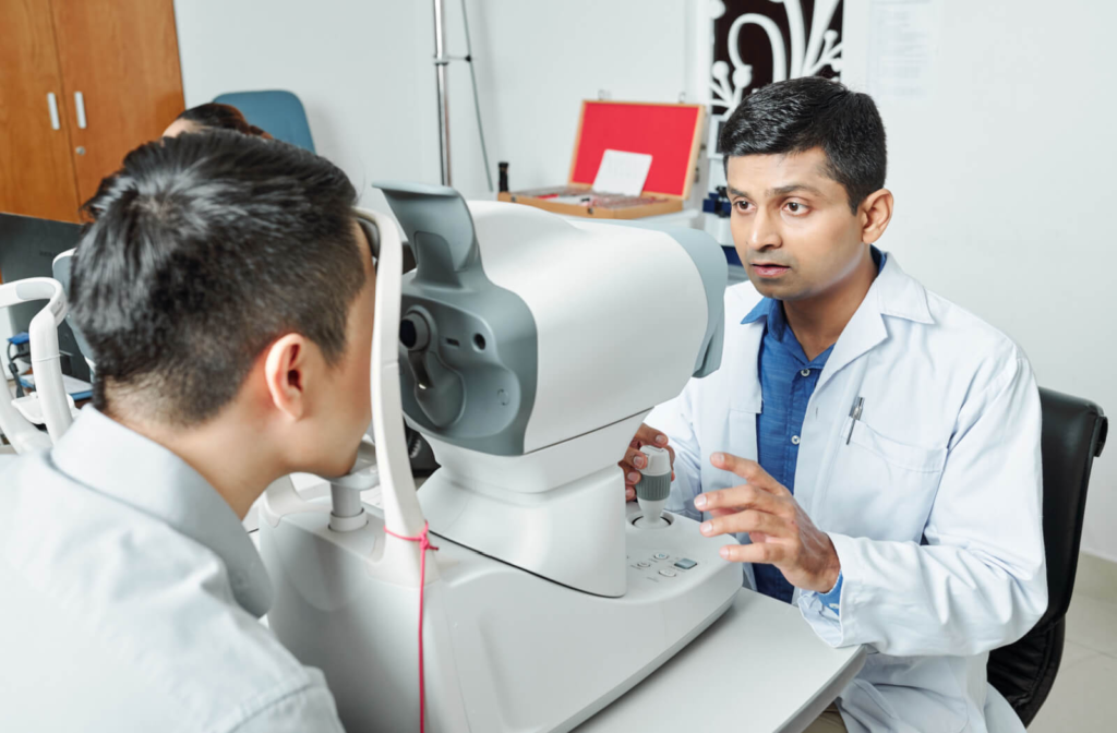 An optometrist operating a retinal imaging machine to capture high-resolution images of the back of a patient's eye.