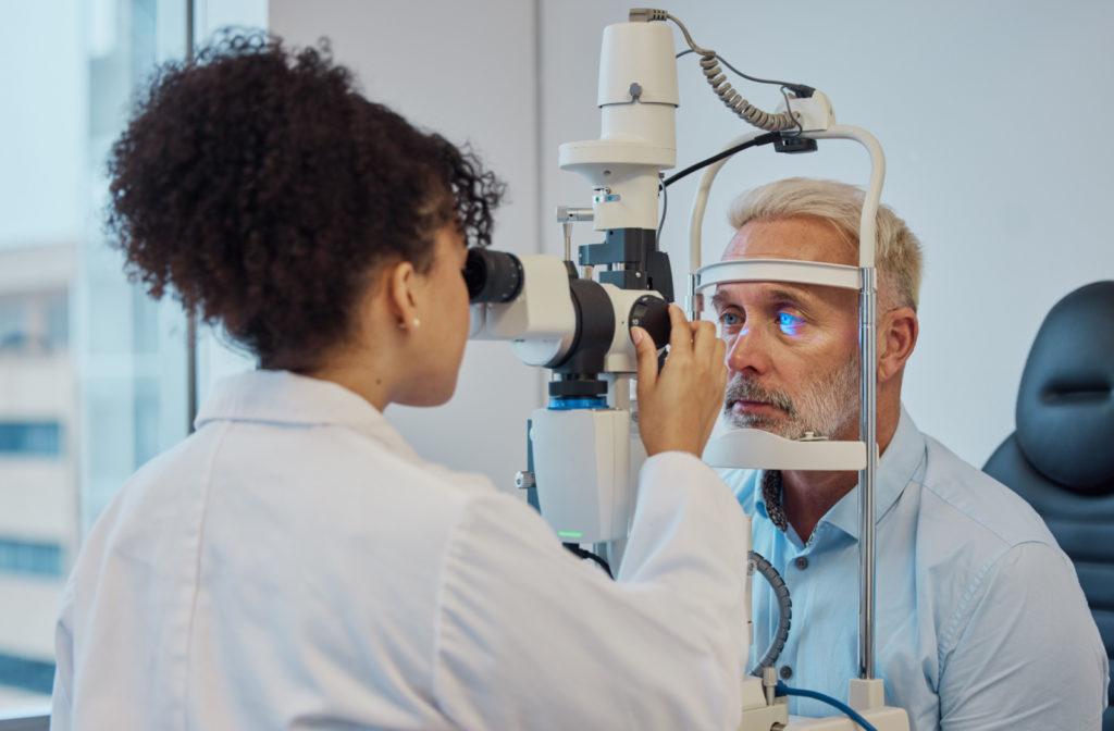 An optometrist conducting an eye exam for her patient.
