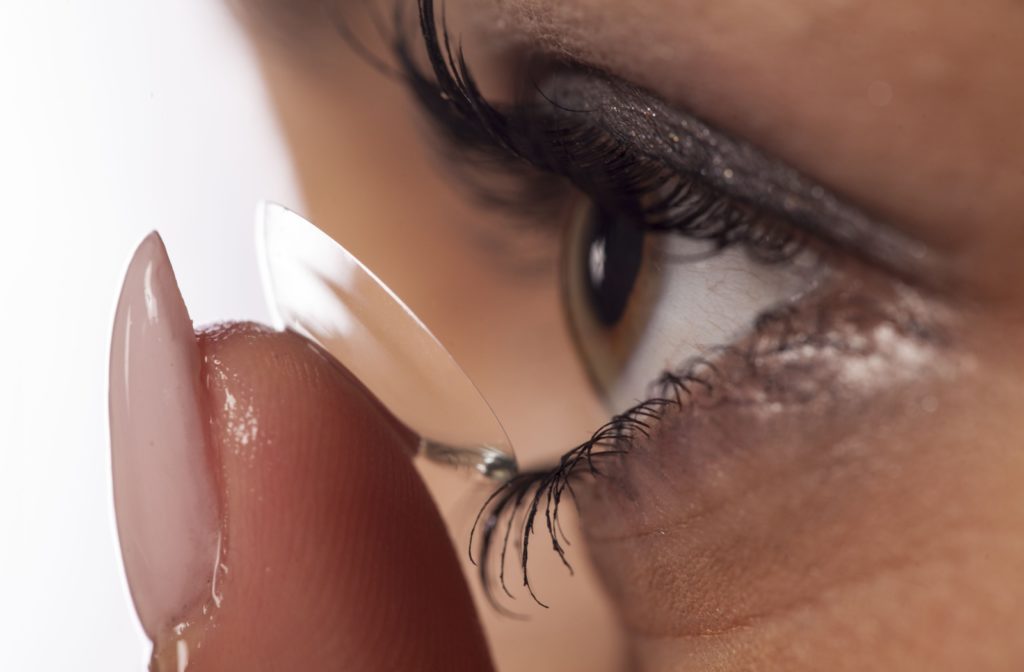 A close-up of a patient inserting their soft contact lens.