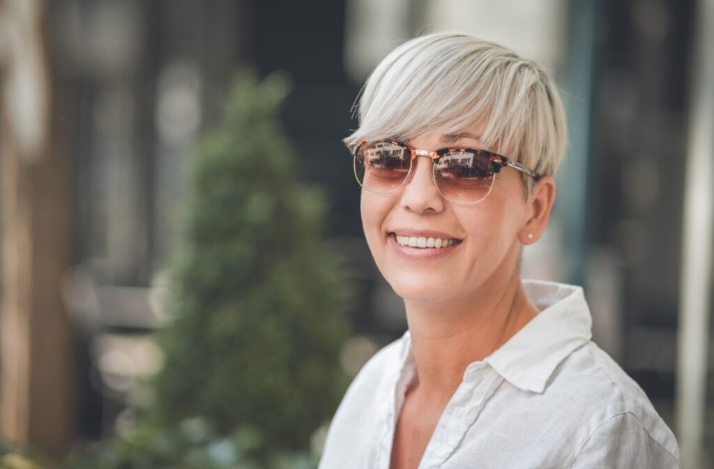 A person wearing sunglasses year round to protect their vision.